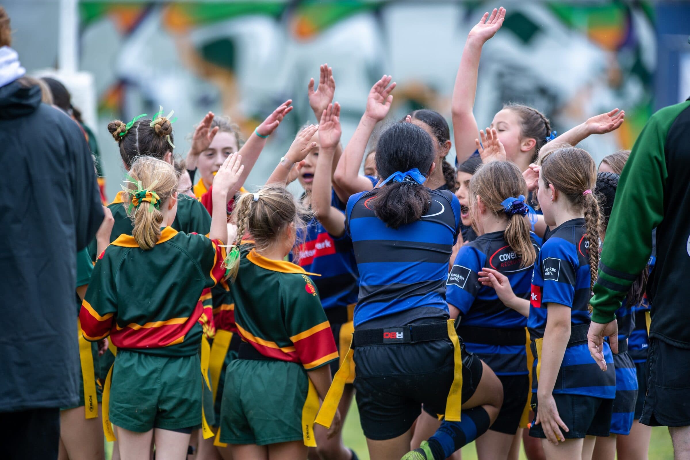 Young players throwing their hands up as they celebrate together