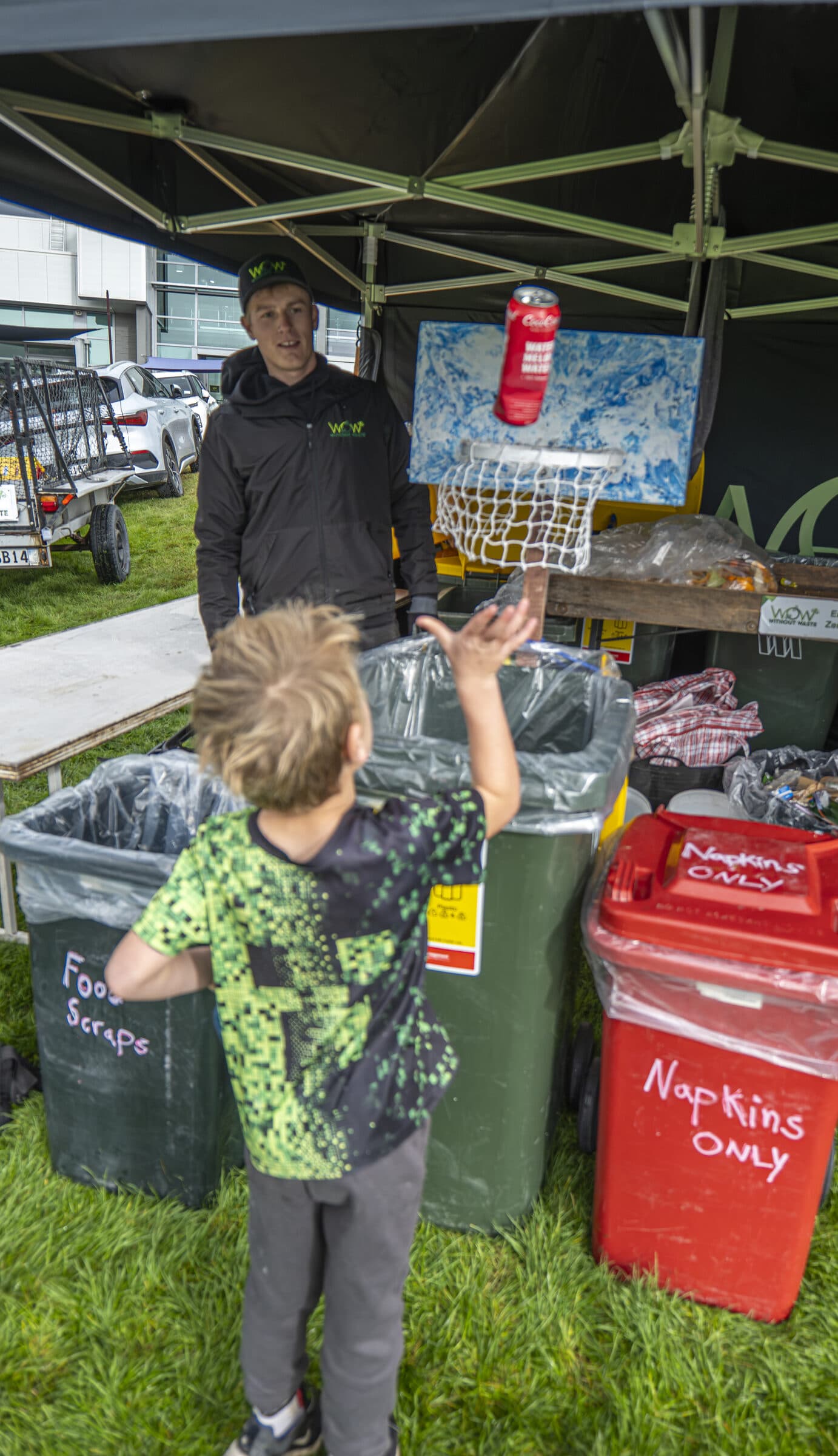 A young volunteer sorting recycling at a Global Games zero-waste station